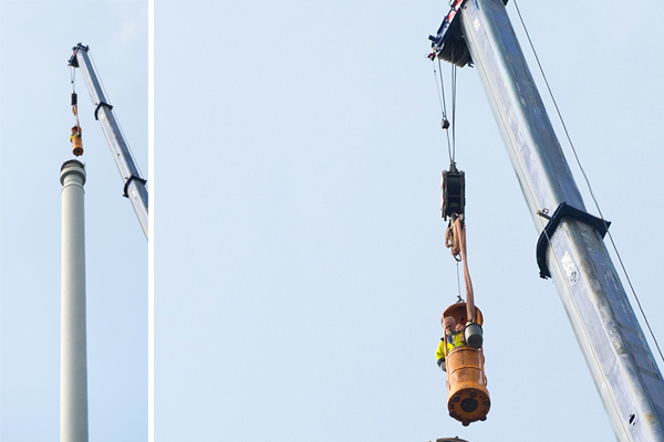 55 Meter hoch ist der Kamin, den ein Mitarbeiter prüft (Foto: Markus Schmidt / Evonik).