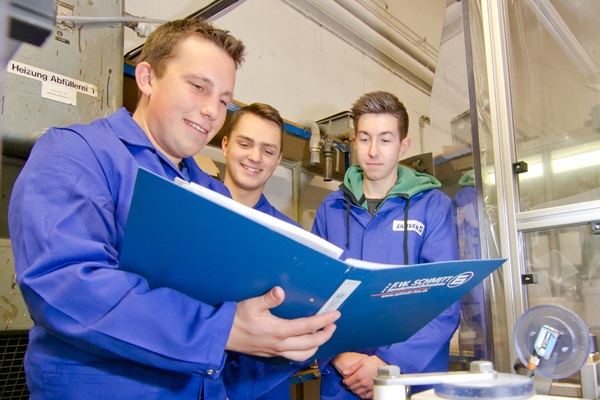 Florian Thelen, Ausbilder der Chemikanten, mit zwei Azubis in der Produktionshalle (Foto: Jansen).